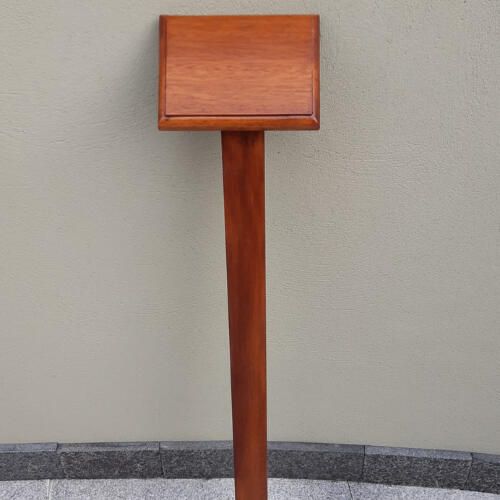 Iroko memorial plaque mounted on a wooden stake